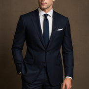 Man wearing a Charcoal grey suit with a white shirt and tie on a brown background